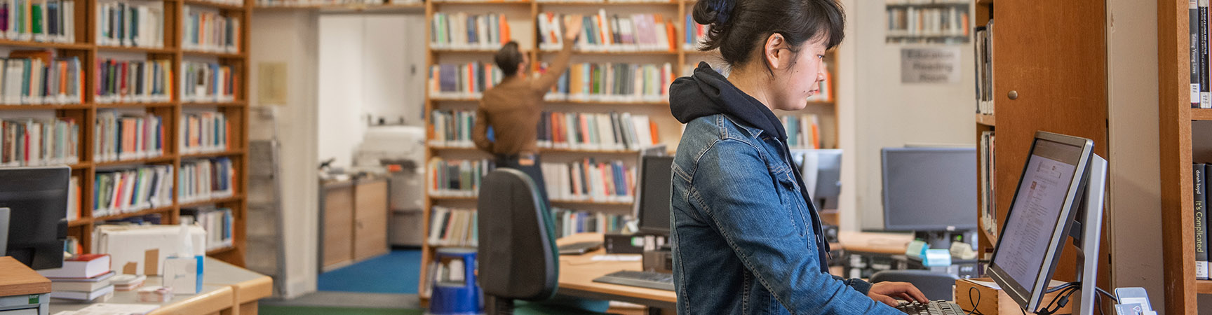 A woman uses a library PC