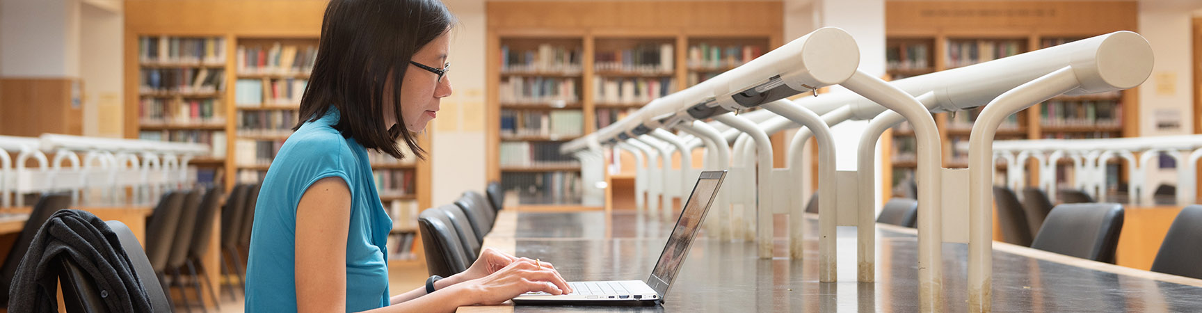 A student working on a laptop at a desk