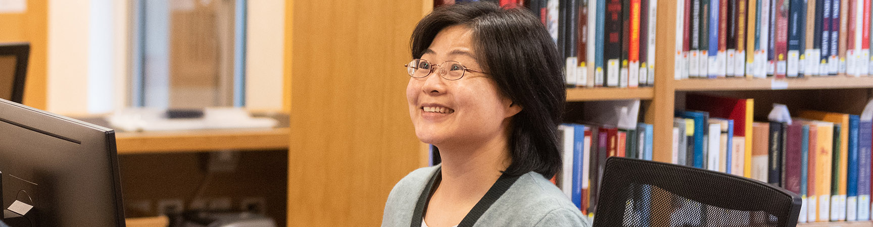 A librarian smiling at the camera