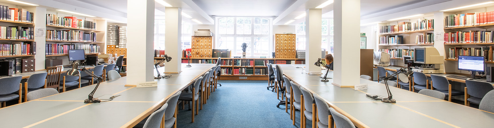 Two rows of desks with bookshelves on each side