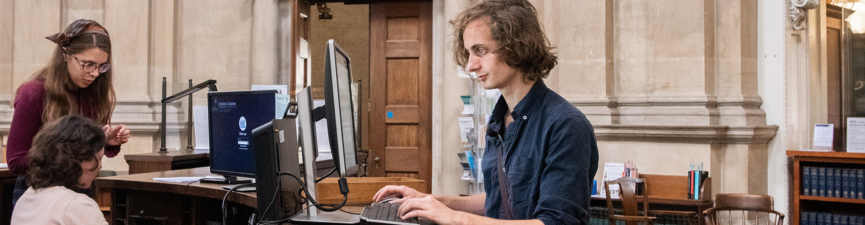 A student looks at a computer - they are standing up