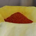 A pile of ground red safflower petals in a cloth