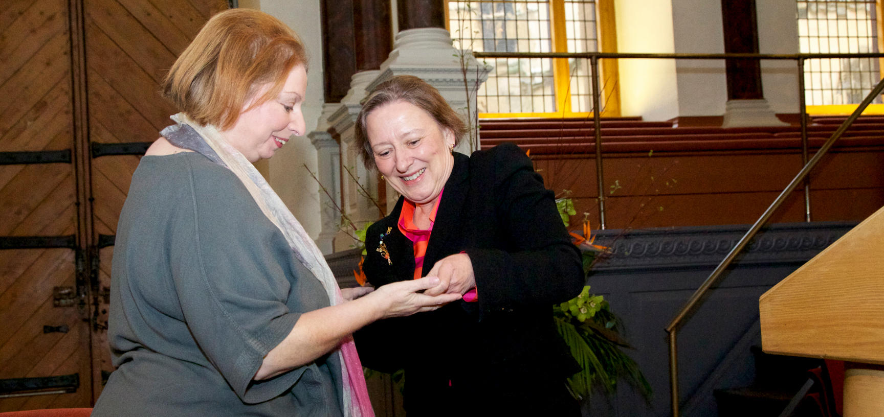 Two women look at the Bodley Medal