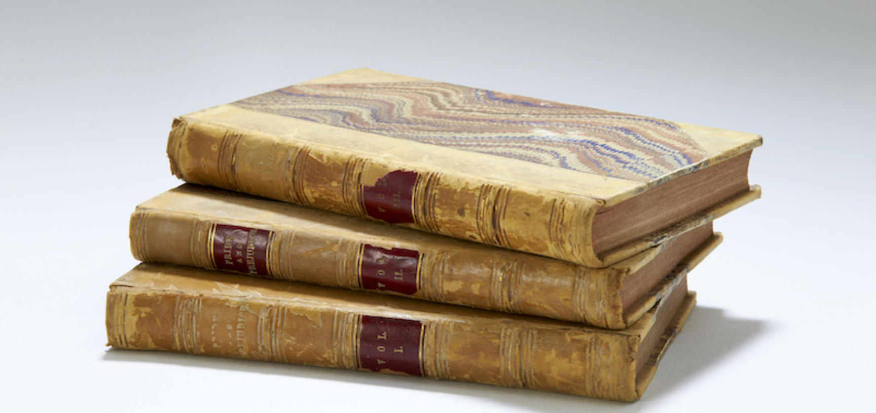 Three books in a stack with old binding