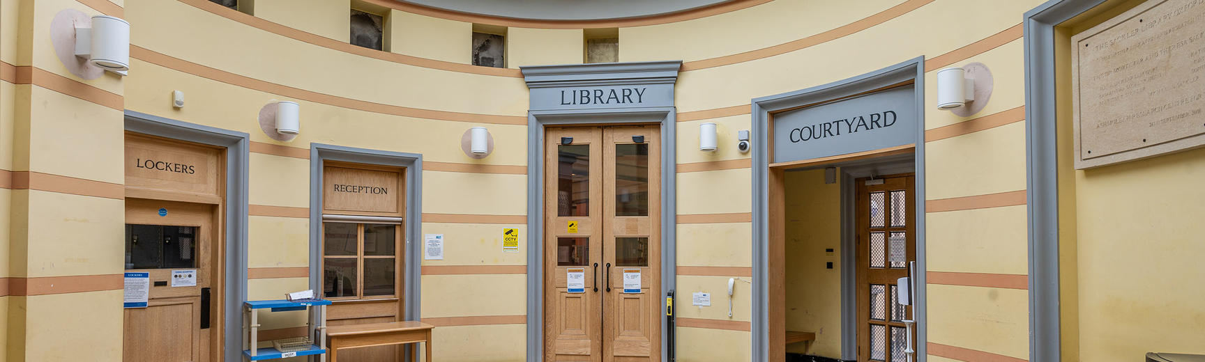 A decorated rotunda showing a wooden door entrance to the library