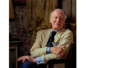 Portrait of John Gielgud - an older white male balding with white hair, dressed in a cream blazer, blue shirt and navy tie, sitting in a wooden chair looking to the right with a tapestry in the background, holding a cigarette in one hand