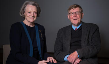 Dame Maggie Smith and Alan Bennett sit against a dark background
