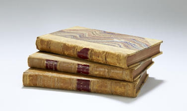 Three books in a stack with old binding