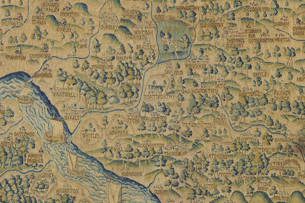 A section of a tapestry map embroidered with woodland, rivers and places