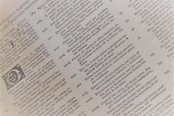 A slanted view of a page of printed type with illumination