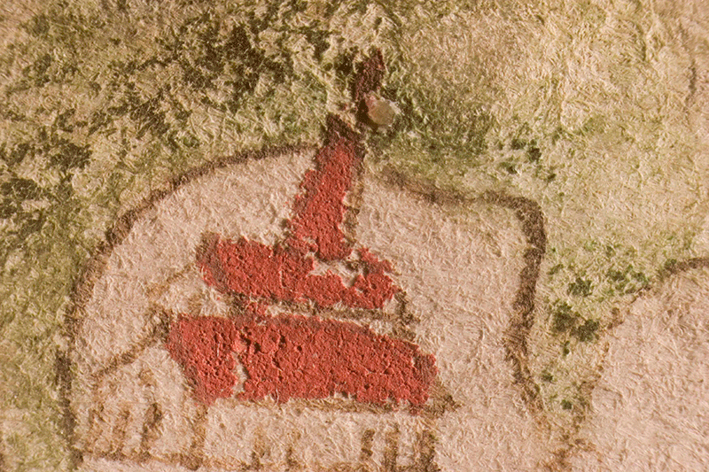 A detail of the Gough Map showing a brick red roof on a building - some of colour has flaked away
