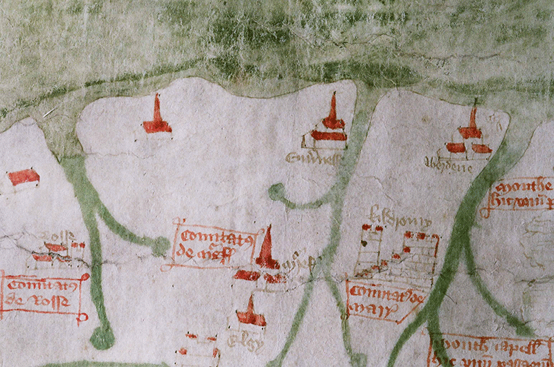 A detail of the map: at the top is a green area. Three strands of green come down into a beige area. Individual small buildings with red roofs are dotted throughout the remaining area