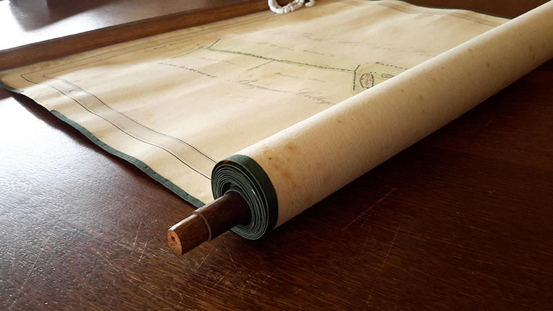 A portion of a scroll unrolled on a wooden table