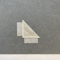 A piece of paper folded diagonally into a triangle, with a flap on the bottom and the left hand side