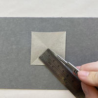 A square piece of paper cut with a ruler and scalpel