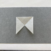 A square piece of paper missing one triangular quarter