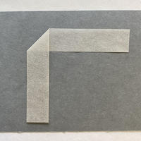 A strip of paper folded over itself in the middle to form a triangular corner