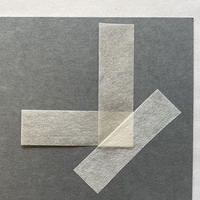 A piece of paper folded into a 'L' shape with another piece of paper covering it diagonally