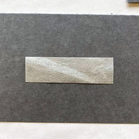 A rectangular piece of paper against a grey background