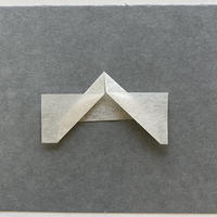 3.4 Style 3: Loose mounting corners, "Frog legs" A piece of paper with tabs folded outward leaving a margin to hold the item