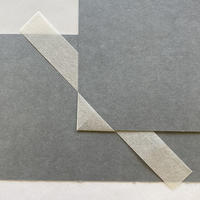 4.6 Style 4: Loose mini mounting corners A corner of paper mounted on the edge of a grey piece of card, with a long rectangular paper strip under the grey